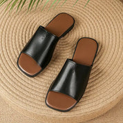 Margolaine Dubreuil | Black Faux Leather Flat Slide Sandals